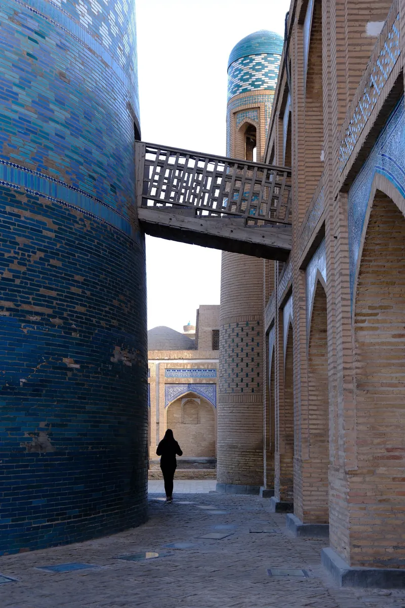 The Kalta Minor minaret and a wooden bridge in Khiva