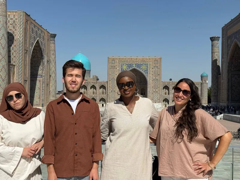 Our guide with three guests at Registan Square, Samarkand